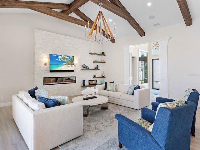 living room featuring beamed ceiling, decorative columns, an inviting chandelier, and light hardwood / wood-style floors