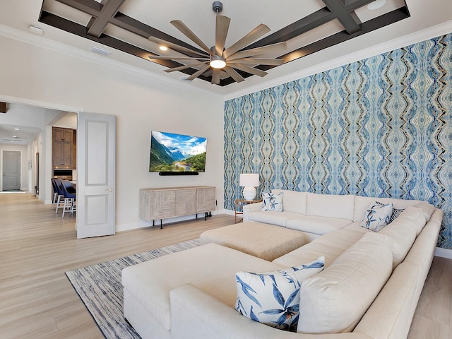 living room with ceiling fan, beam ceiling, crown molding, and coffered ceiling