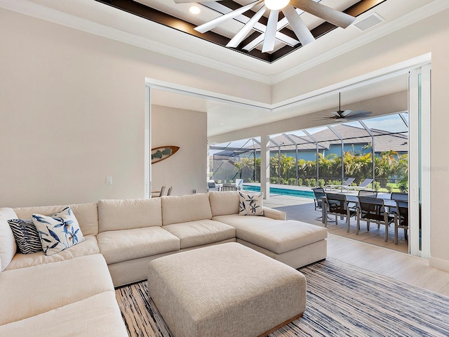 living room with a wealth of natural light, crown molding, hardwood / wood-style floors, and ceiling fan