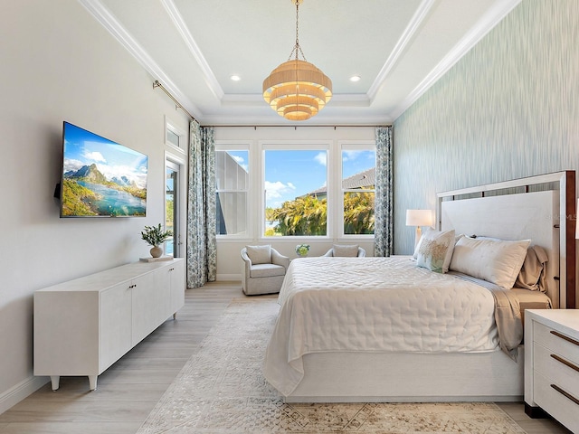 bedroom with a tray ceiling, light hardwood / wood-style flooring, and ornamental molding