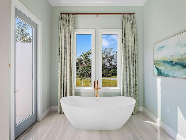 bathroom with tile patterned flooring and a bath