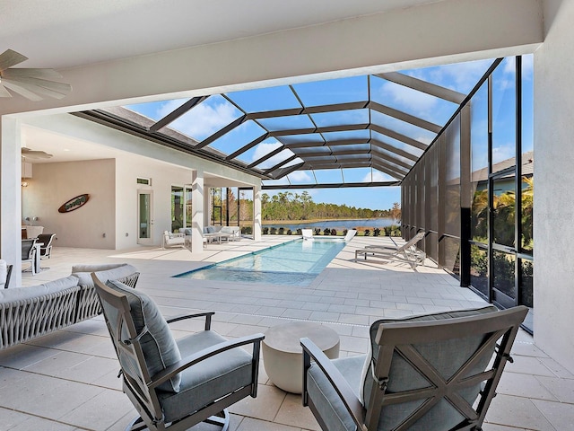 view of pool featuring a lanai, outdoor lounge area, ceiling fan, and a patio