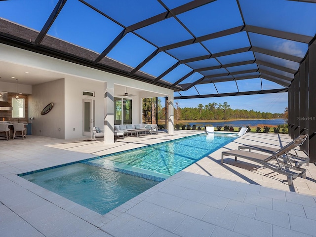 view of swimming pool with an outdoor living space, a patio, ceiling fan, and a lanai