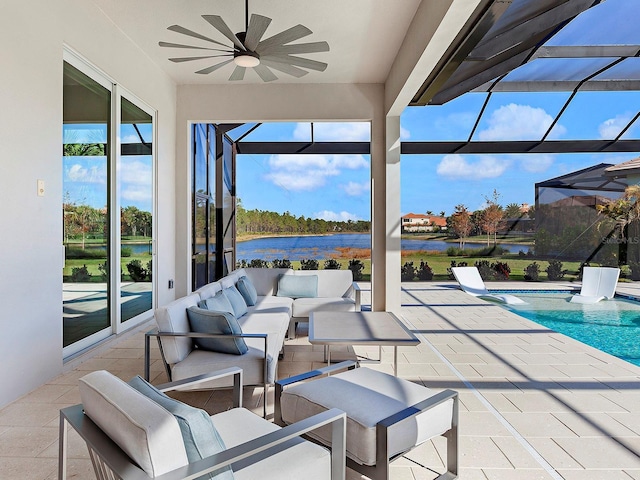 view of patio featuring a lanai, outdoor lounge area, ceiling fan, and a water view