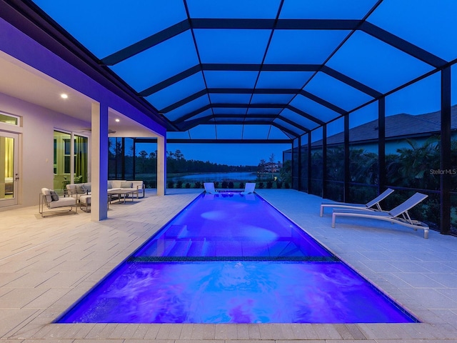 view of pool with an outdoor living space, a patio area, a lanai, and an in ground hot tub