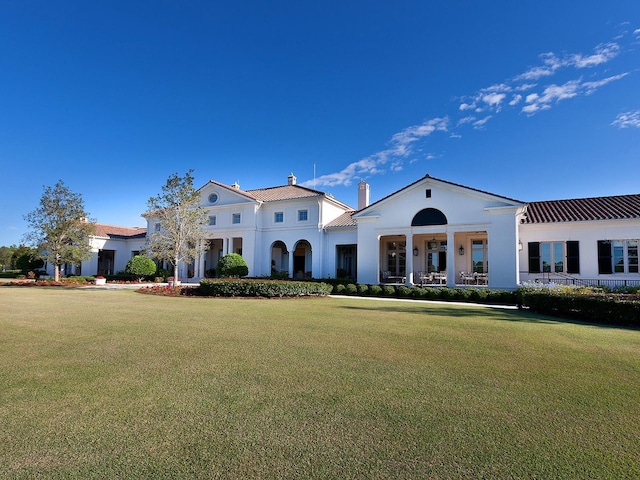 mediterranean / spanish-style house with a front lawn