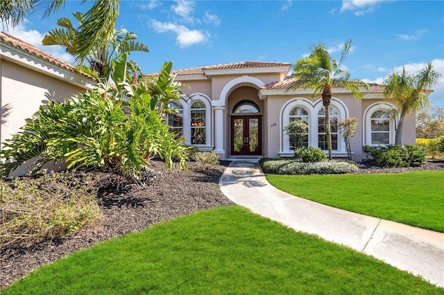 property entrance featuring french doors and a lawn