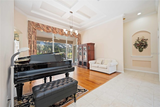 sitting room with hardwood / wood-style floors, ornamental molding, a notable chandelier, and coffered ceiling