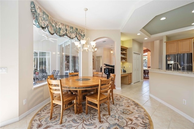 dining area featuring ceiling fan with notable chandelier and light tile patterned flooring