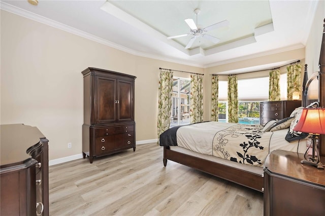 bedroom with ceiling fan, a raised ceiling, access to outside, ornamental molding, and light hardwood / wood-style flooring