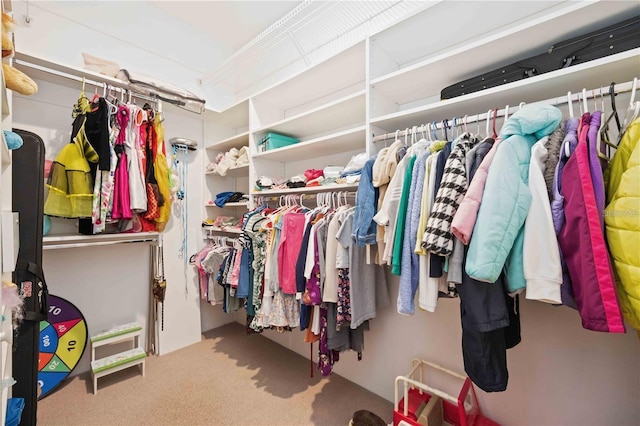 walk in closet with carpet