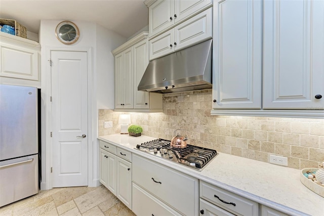 kitchen with tasteful backsplash, light stone countertops, and stainless steel appliances