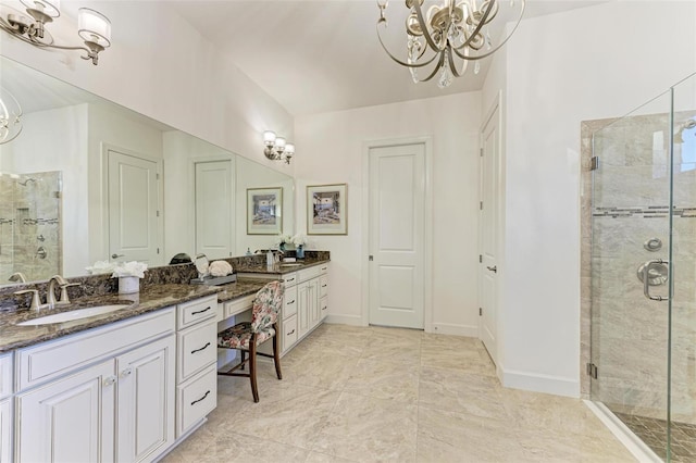 bathroom featuring vanity, walk in shower, and a notable chandelier