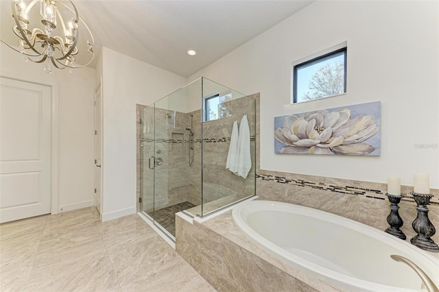 bathroom featuring shower with separate bathtub and an inviting chandelier