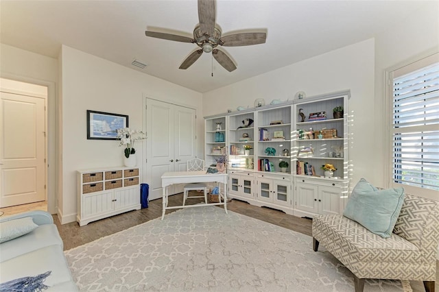 living area featuring ceiling fan and light wood-type flooring