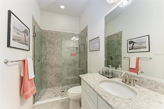 bathroom featuring tile patterned floors, vanity, toilet, and an enclosed shower