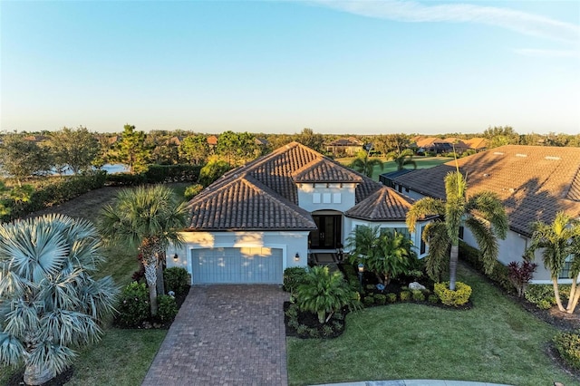 view of front of home with a front lawn and a garage