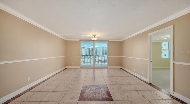 tiled spare room with ornamental molding