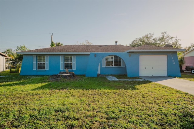 single story home featuring a front yard and a garage