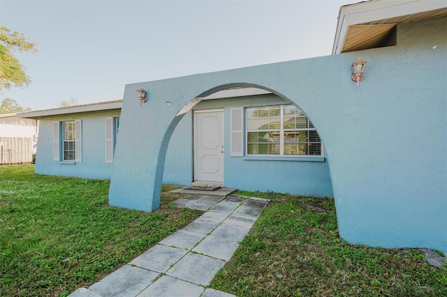 doorway to property with a yard