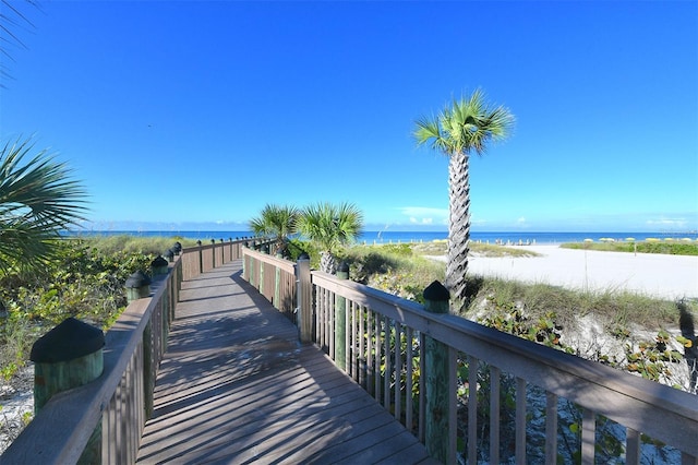 surrounding community with a view of the beach and a water view