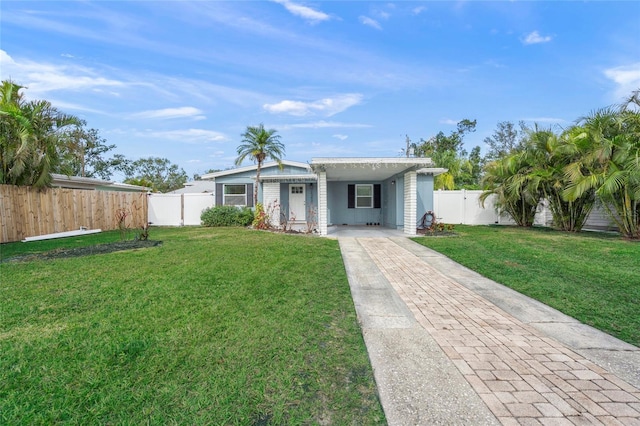 single story home featuring a front lawn and a carport