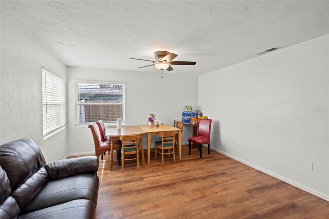 dining area featuring ceiling fan and hardwood / wood-style flooring