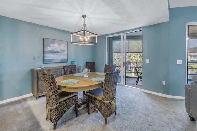 carpeted dining area featuring a chandelier and a textured ceiling