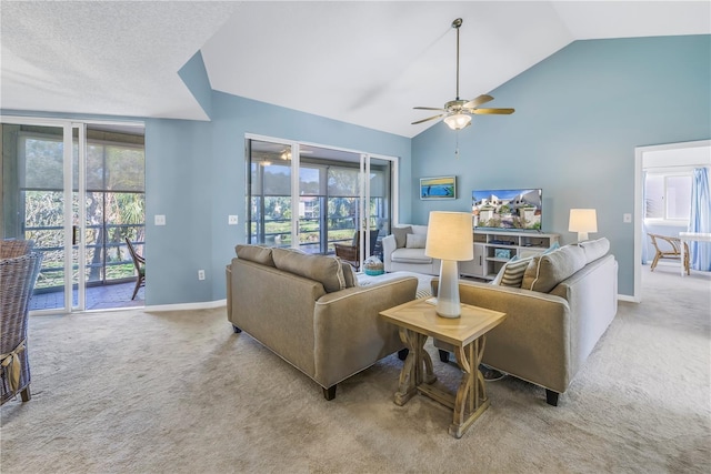 carpeted living room with ceiling fan and vaulted ceiling