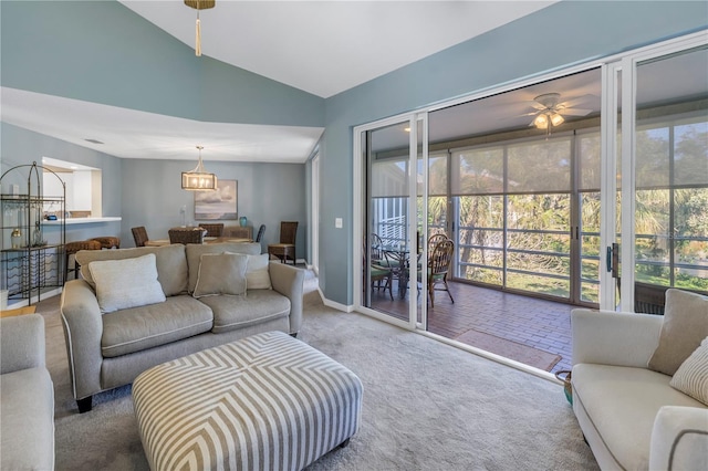 carpeted living room with ceiling fan and lofted ceiling