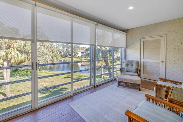 sunroom with a water view and a wealth of natural light