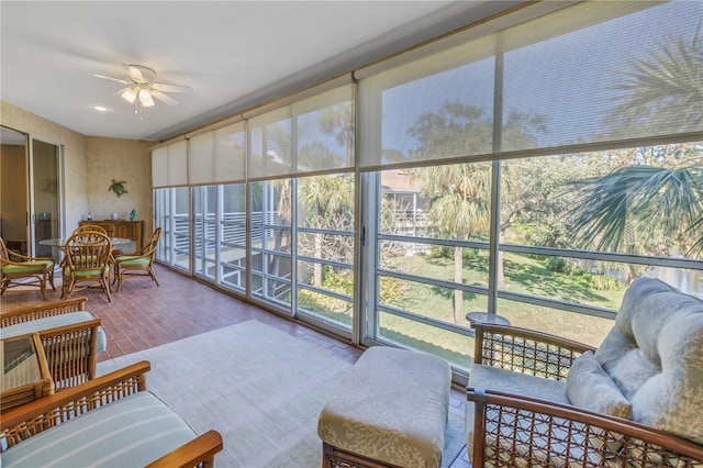 sunroom / solarium with ceiling fan and a healthy amount of sunlight