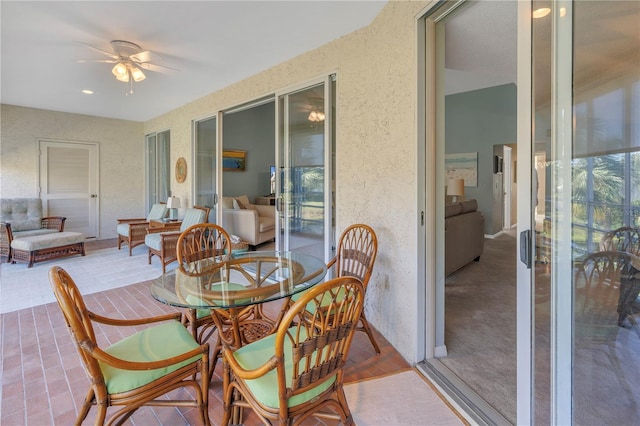 dining space with carpet and ceiling fan