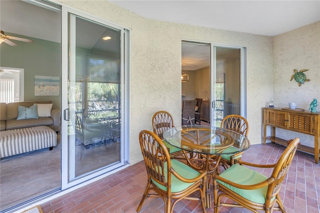 dining space with a wealth of natural light and ceiling fan