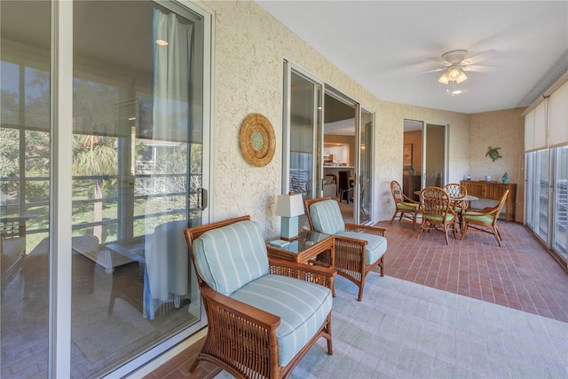 sunroom / solarium featuring ceiling fan