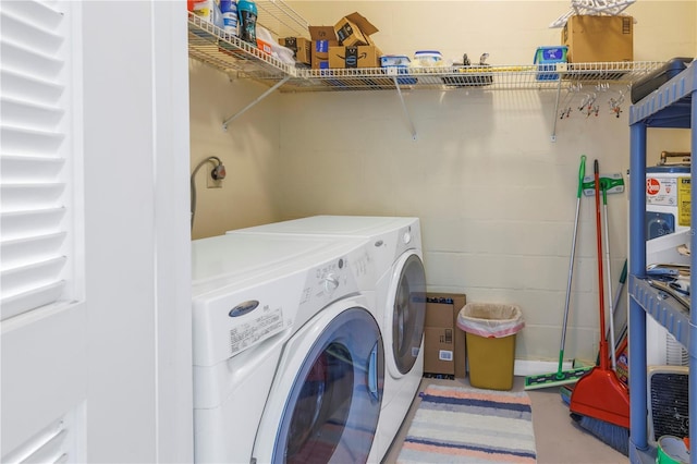 clothes washing area featuring washer and clothes dryer