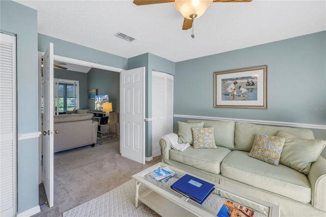 carpeted living room featuring ceiling fan