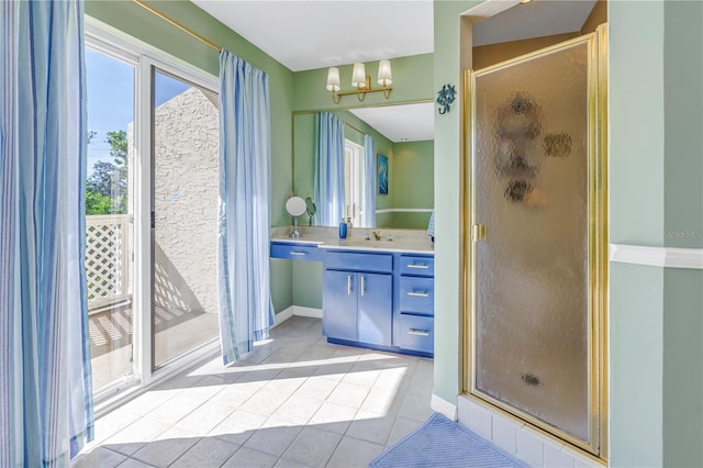 bathroom with tile patterned flooring, a notable chandelier, walk in shower, and vanity