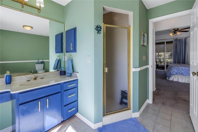 bathroom with tile patterned floors, ceiling fan, vanity, and walk in shower