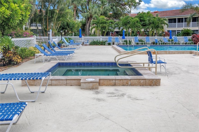 view of swimming pool featuring a patio area and a community hot tub