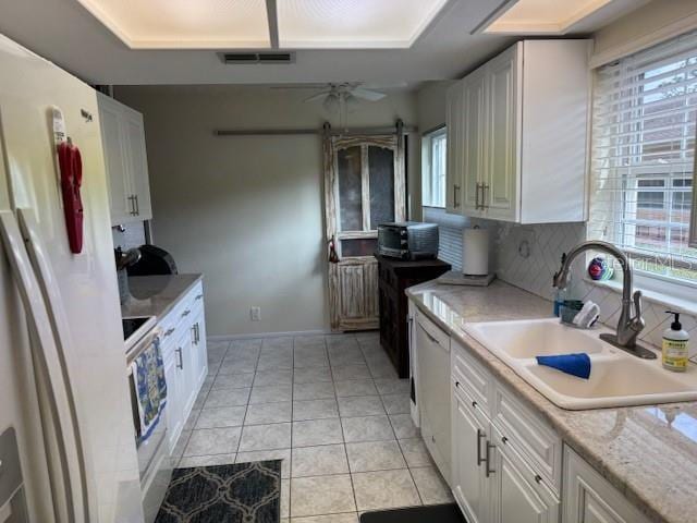 kitchen featuring white cabinetry, sink, ceiling fan, and white appliances