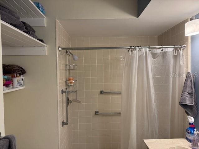 bathroom featuring curtained shower and vanity