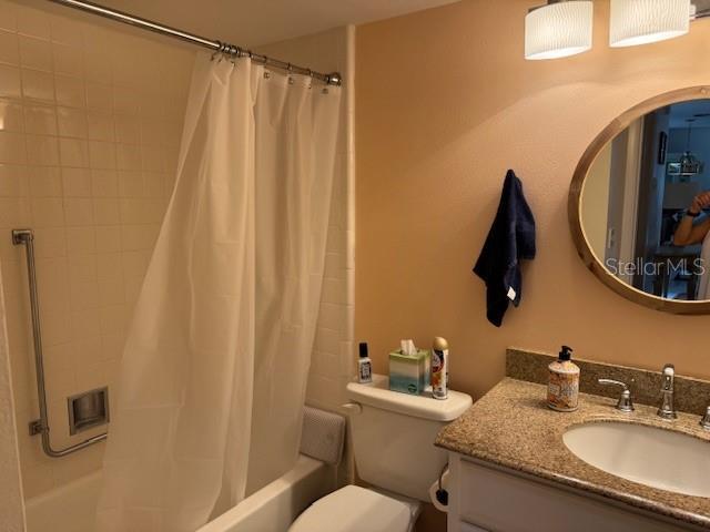 full bathroom with vanity, toilet, and shower / bathtub combination with curtain