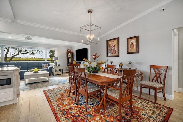 dining area with ceiling fan with notable chandelier, light wood-type flooring, and ornamental molding