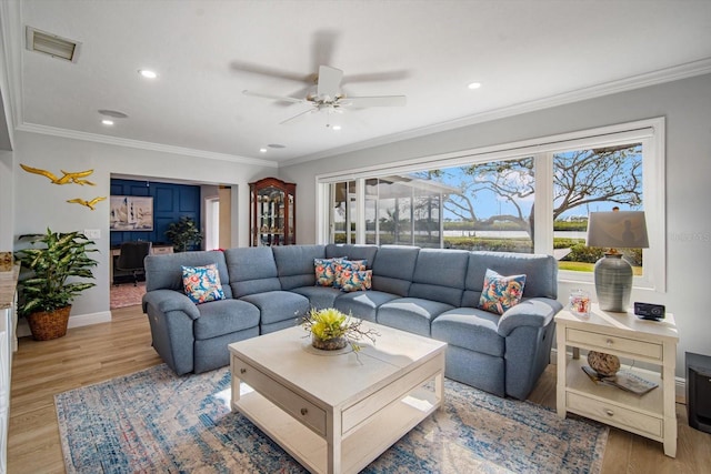 living room featuring crown molding, ceiling fan, and light wood-type flooring