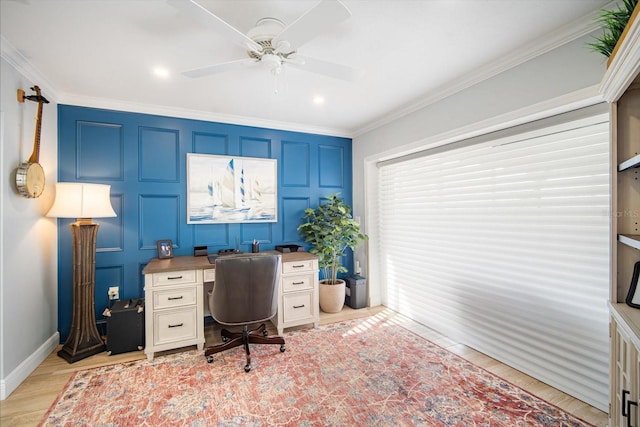 office featuring light hardwood / wood-style floors, ceiling fan, and ornamental molding