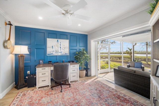 office area featuring ceiling fan, light wood-type flooring, and ornamental molding