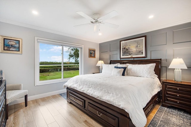 bedroom featuring ceiling fan, light hardwood / wood-style floors, and ornamental molding