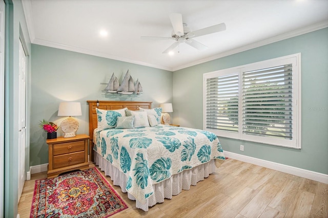 bedroom with ceiling fan, crown molding, and a closet