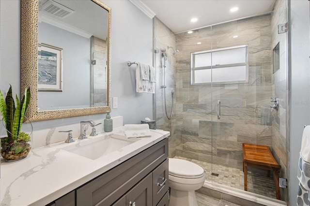 bathroom with walk in shower, toilet, vanity, and ornamental molding